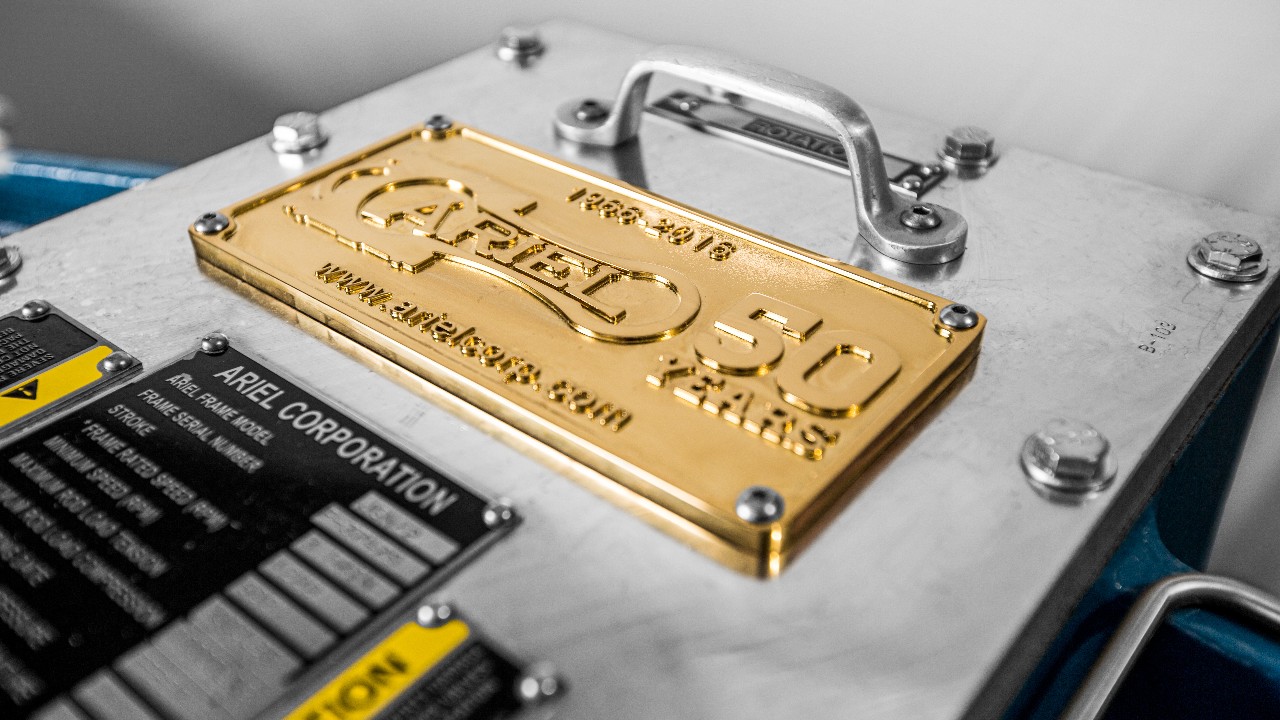 Detail of a gold compressor plate featuring a "50 Years" graphic