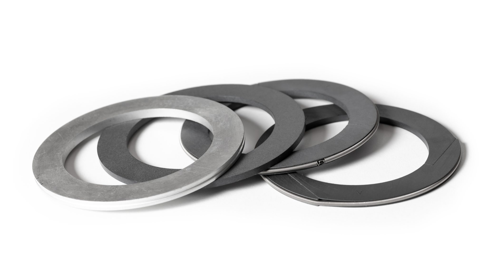 Four BTUU packing rings fanned out on a white background