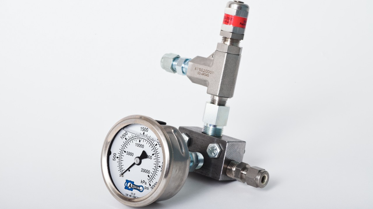 A balance valve with a pressure gauge attached on a white background